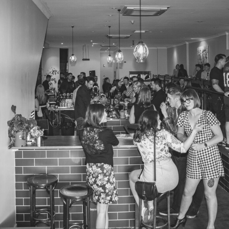 Friends celebrating a 30th birthday with drinks and laughter at a Richmond function venue.