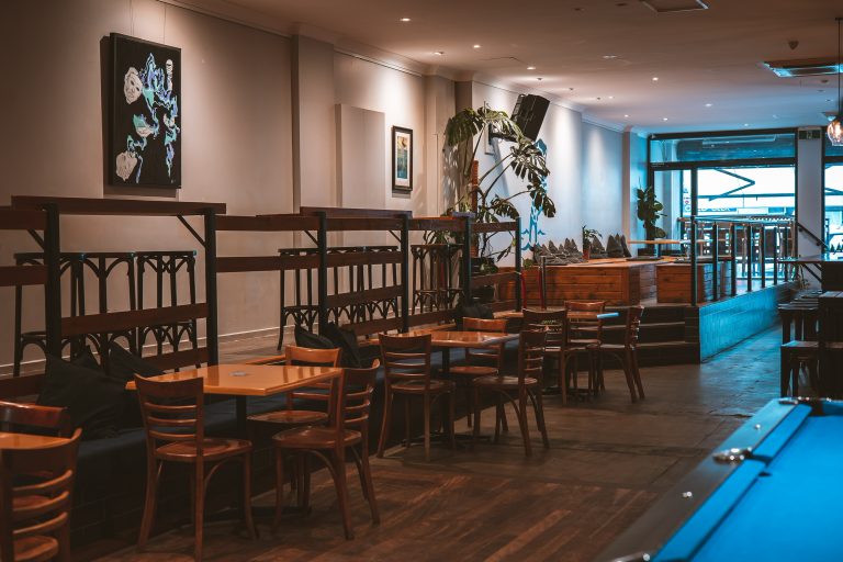 Spacious interior of a function venue in Richmond with wooden tables and chairs set up for events.