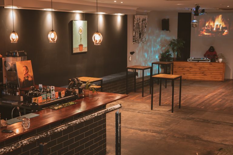Open function space with high tables and DJ setup inside a Richmond function venue.