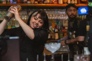 Bartender shaking a cocktail behind the bar at a Richmond function venue