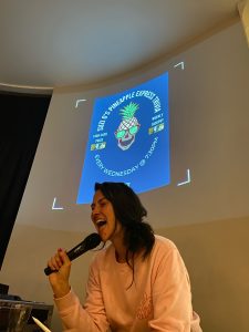 Trivia host holding a microphone in front of a projected Pineapple Express Trivia screen at a Richmond bar and function venue